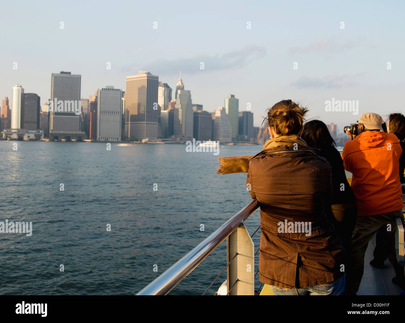 Tourists looking at manhattan from an Ikea bound NYC water taxi Stock