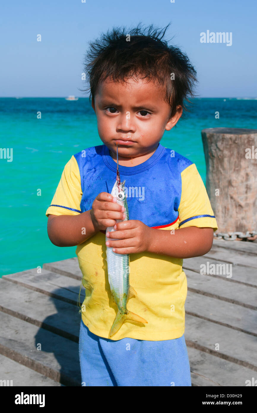 Young Mayan boy holding a fish. Stock Photo
