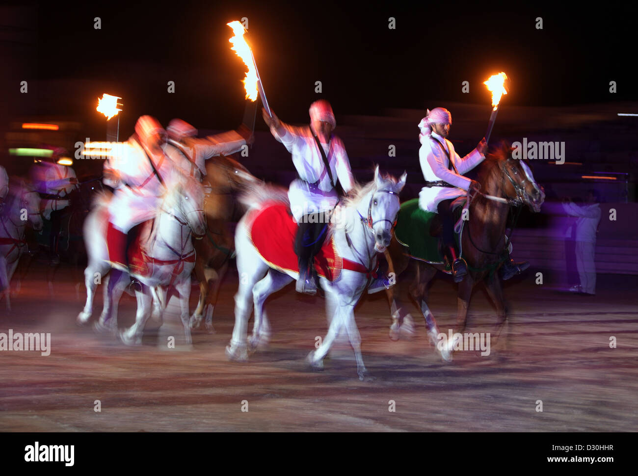 Dubai, United Arab Emirates, Arab horsemen in national costume on full Blue Tern Stock Photo