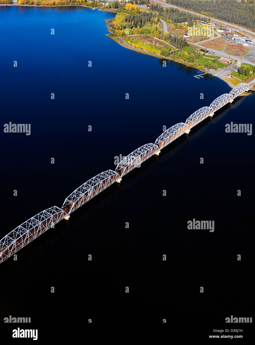 The long Teslin Bridge and the Alaska Highway crossing Nisutlin Bay in the Yukon Territory in Canada. An aerial stock photo. Stock Photo
