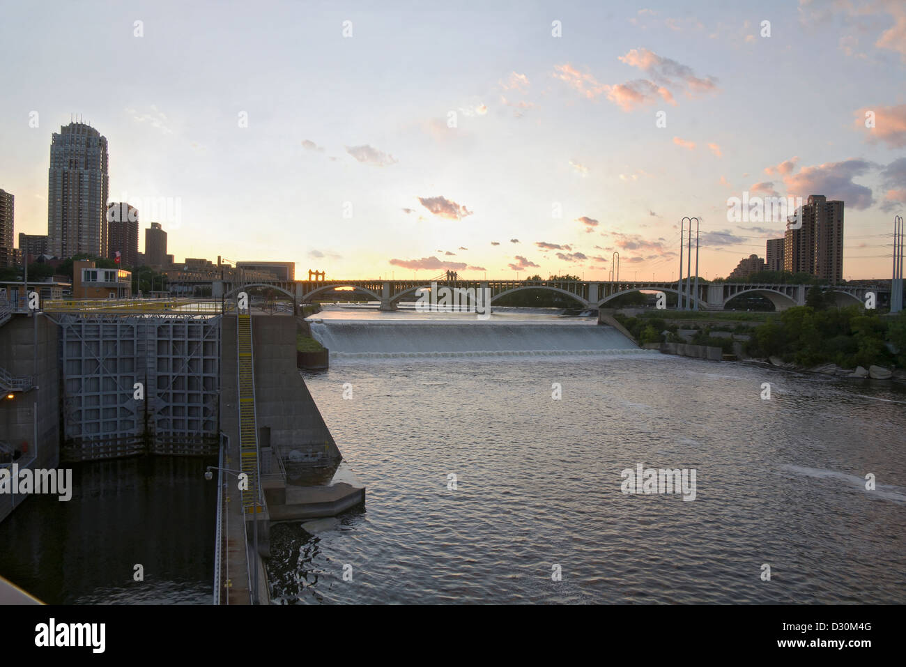 Upper Saint Anthony Falls with lock and dam and 3rd Avenue bridge on Mississippi River in downtown Minneapolis Stock Photo