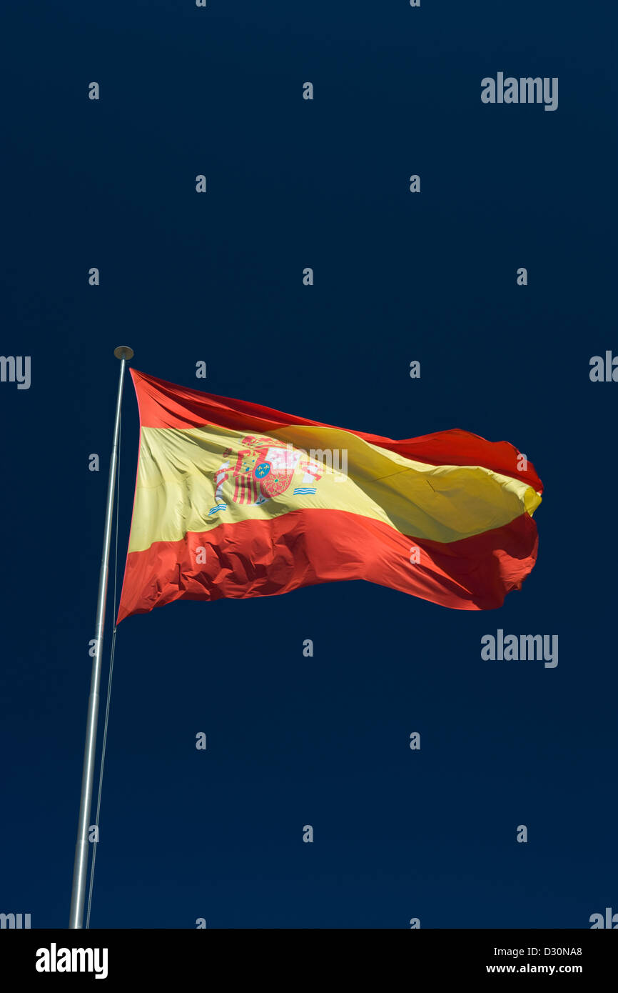 LARGE SPANISH FLAG FLYING ON FLAG POLE WITH BLUE SKY BACKGROUND Stock ...