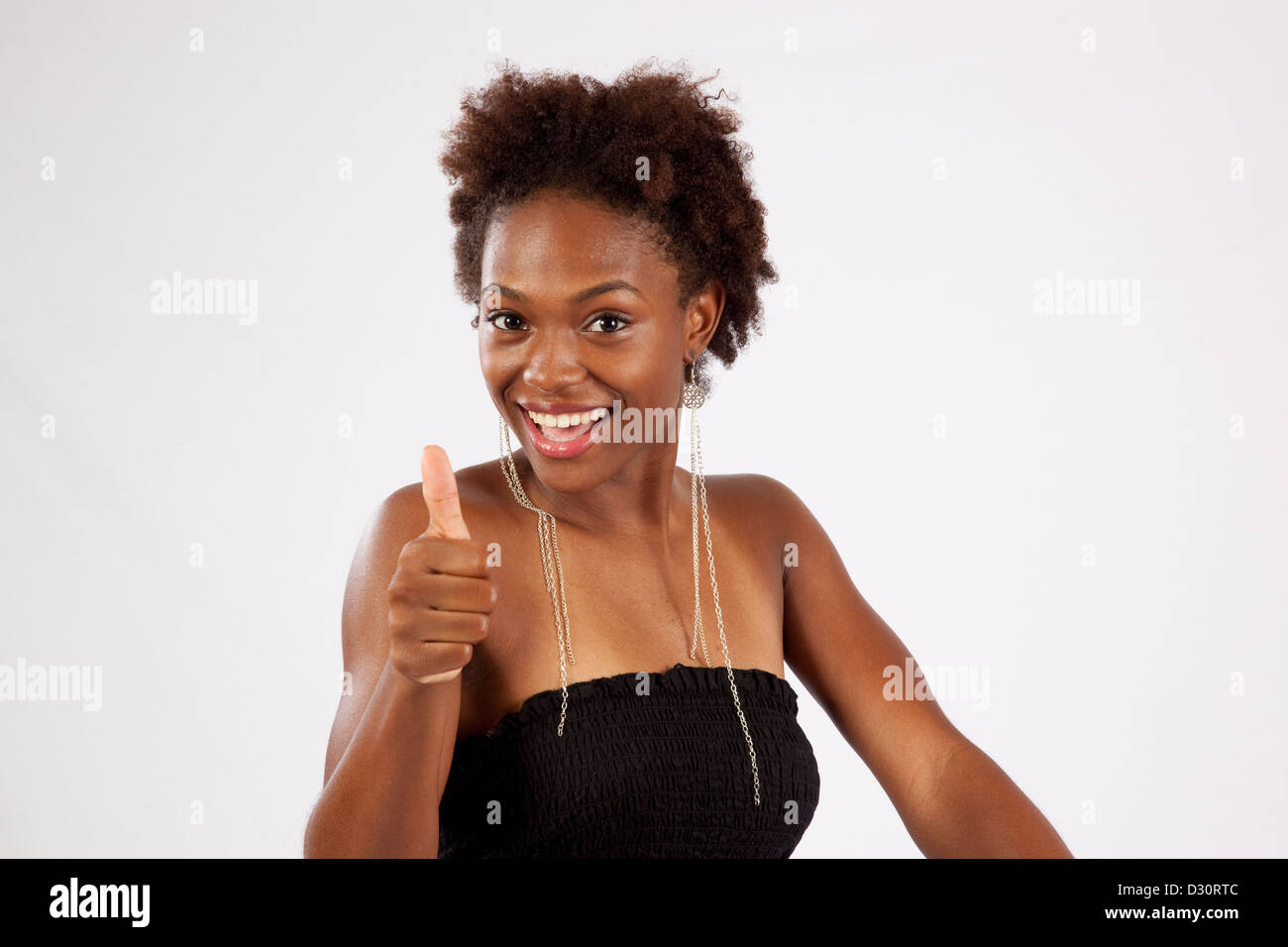 Pretty black woman looking at the camera with a flirting, happy smile ...