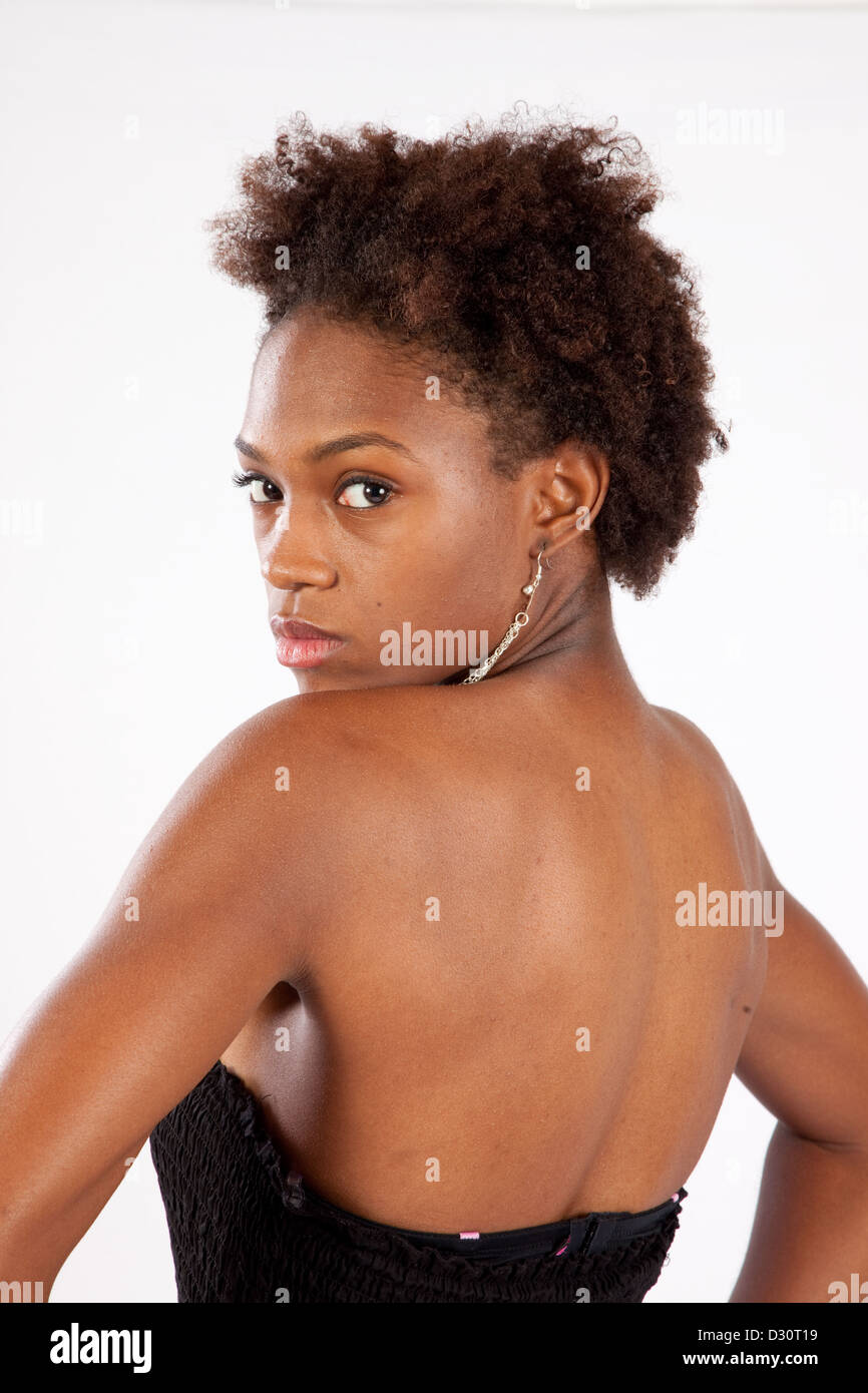 Lovely black woman looking over her shoulder with a thoughtful and