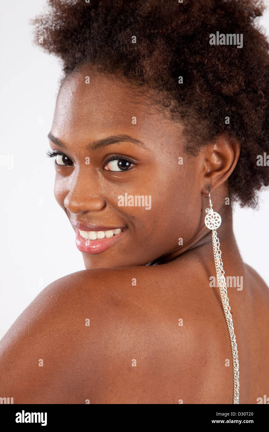 Lovely black woman looking over her shoulder with a happy smile and a ...