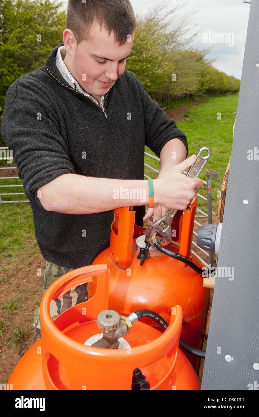 Gamekeeper altering heating levels for young pheasant hut on gas