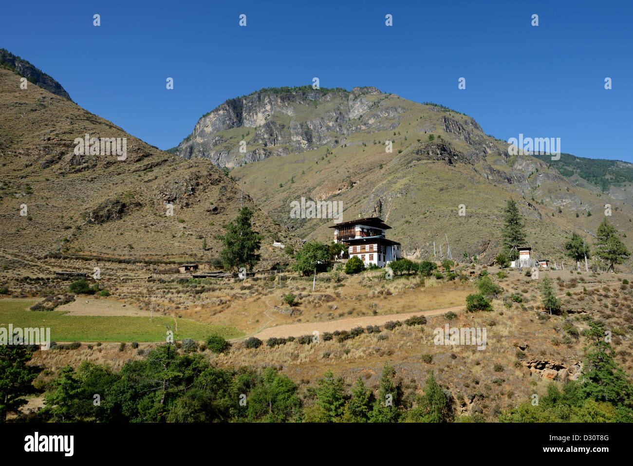 Bhutanese temple, Tachog Lhakhang, with mountain in distance,36MPX,HI-RES Stock Photo