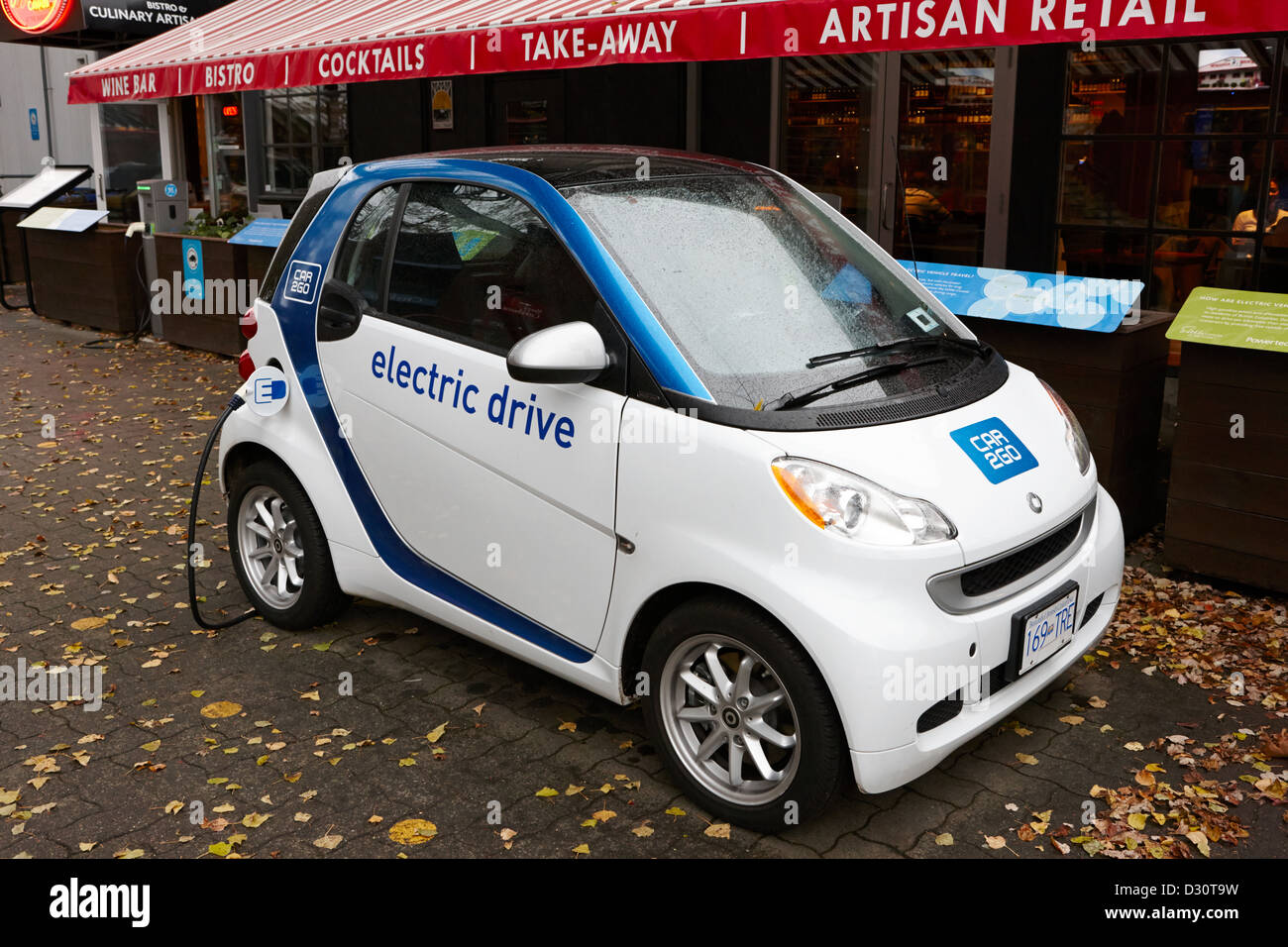 car sharing car2go electric car charging at a parking spot in Vancouver BC Canada Stock Photo