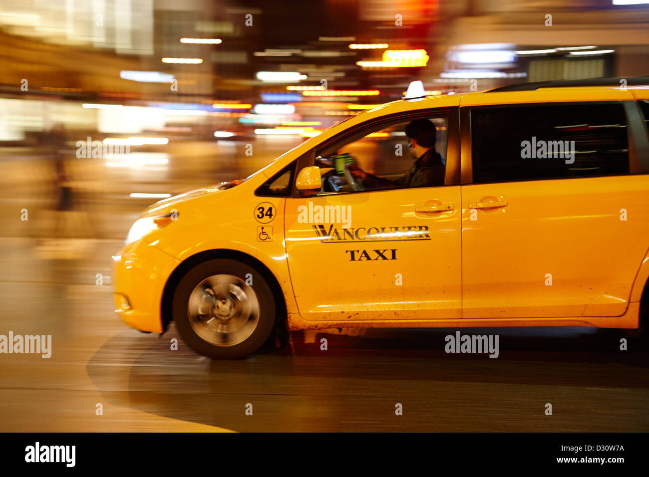yellow cab taxi downtown Vancouver city at night BC Canada deliberate