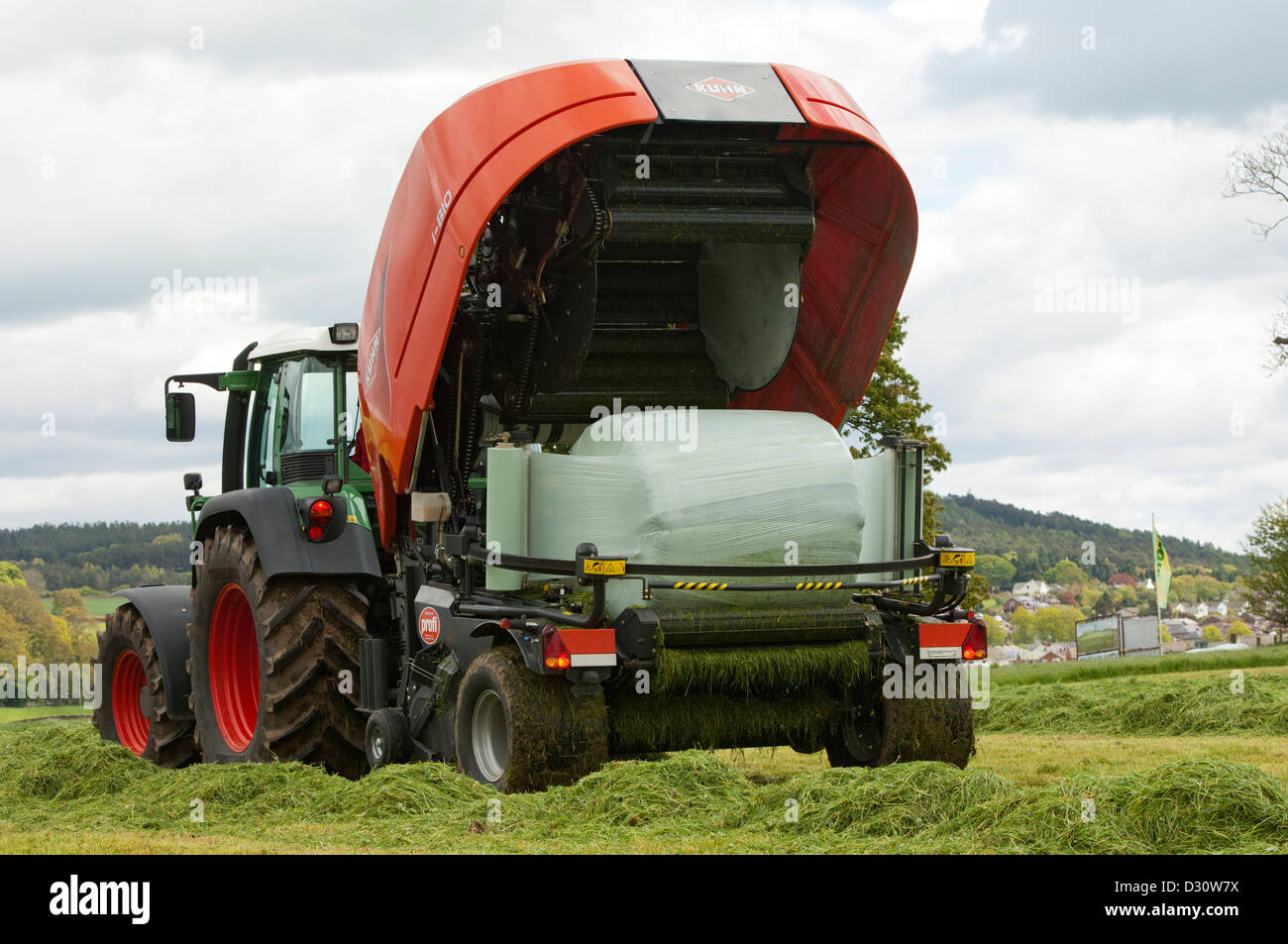 Kuhn all in one baler and wrapper at work in silage field. Stock Photo