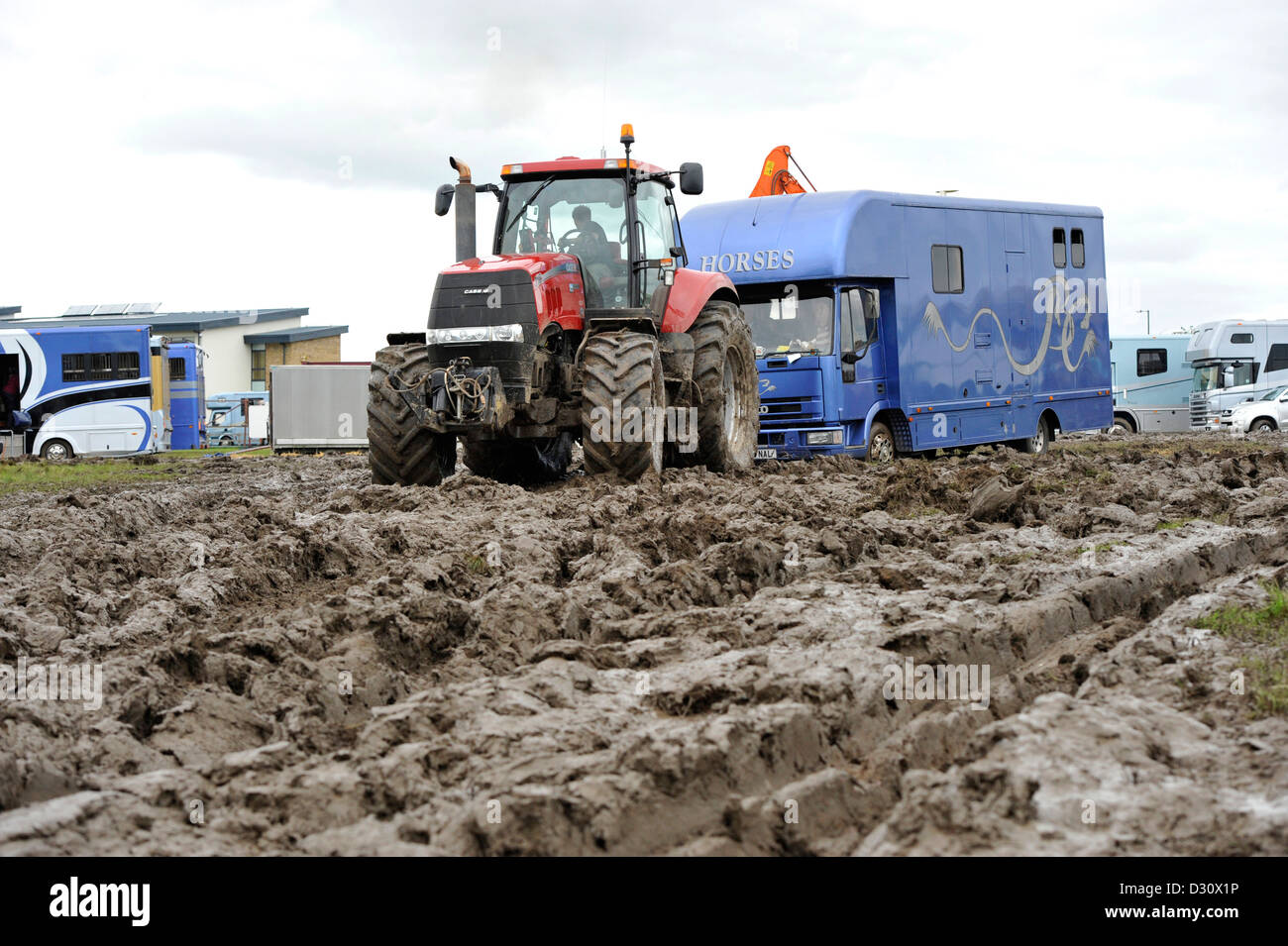 Tractor pulling horsebox out of the muddy car park at the Yorkshire Show 2012, which was cancelled due to bad weather. Stock Photo