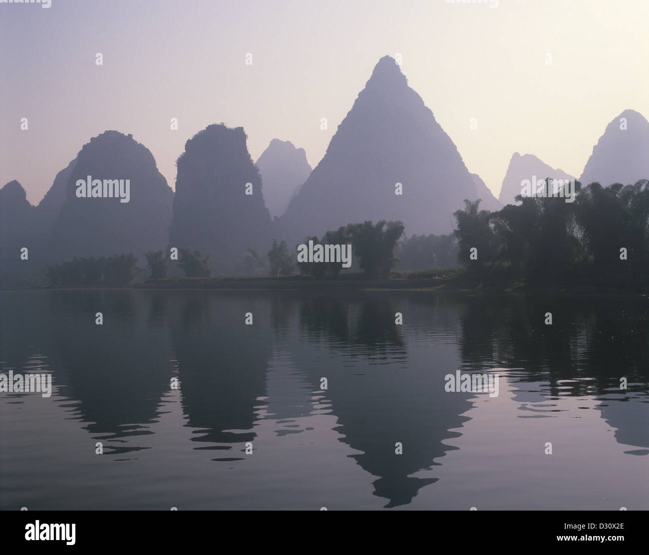 Peoples Republic of China, Guangxi, Yangshuo, limestone pinnacles reflecting in Li River Stock Photo