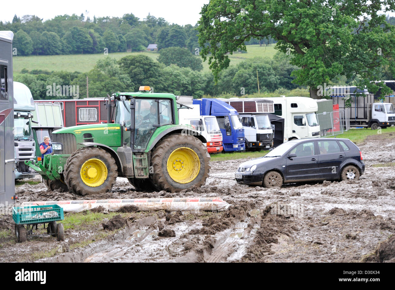 Tractor pulling car out of the muddy car park at the Yorkshire Show 2012, which was cancelled due to bad weather. Stock Photo
