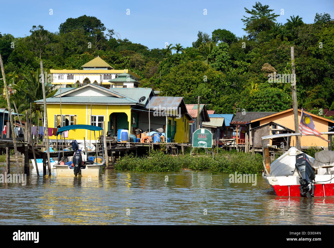 Village and houses along a river. Sarawak, Borneo, Maylaysia. Stock Photo