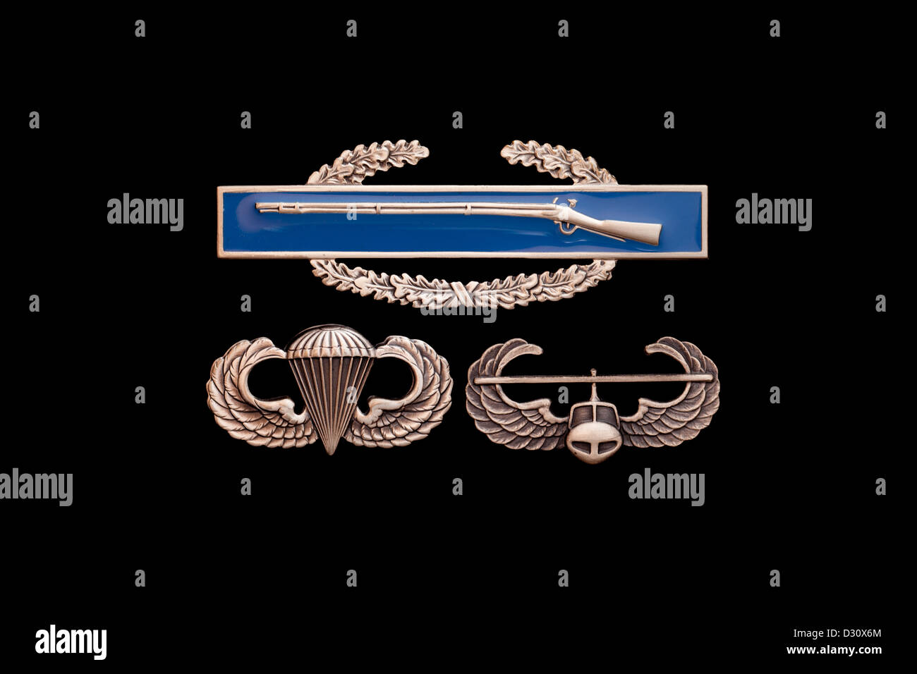 Army Combat Infantry Badge (CIB) over Airborne wings and Air Assault badge on black Stock Photo