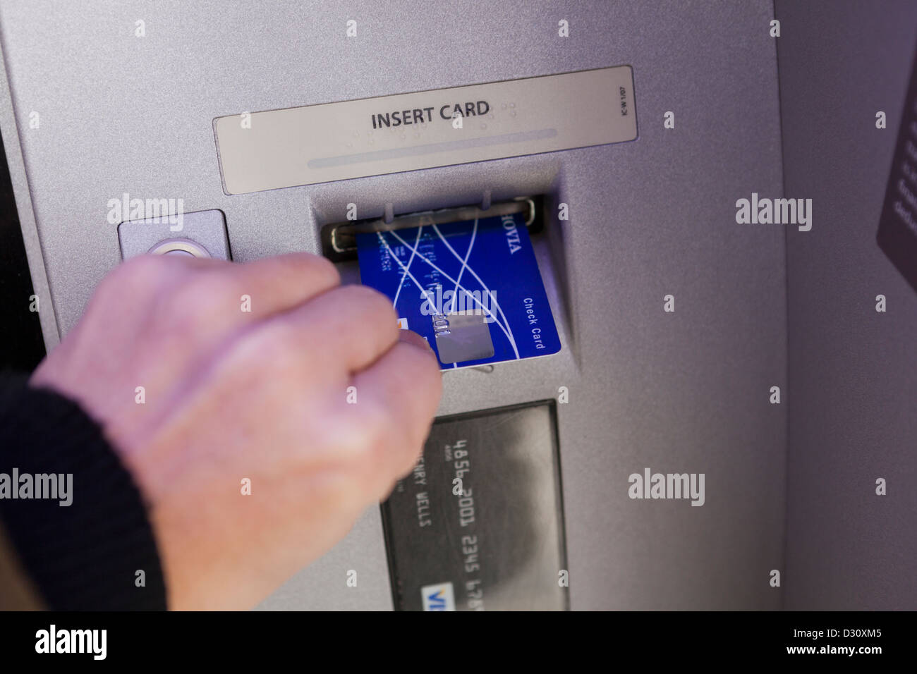 Man inserting bank card into ATM - USA Stock Photo