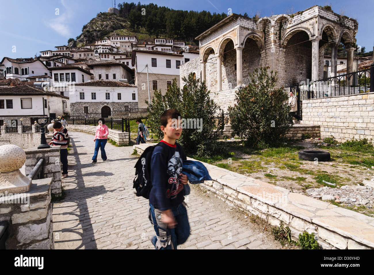 Schoolchild next to the ruins of the Pasha's palace in Mangalem quarter, Berat, Albania Stock Photo