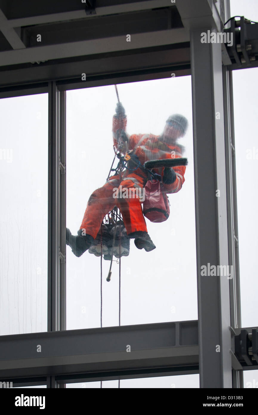London City The Shard abseiling window cleaner outside 69th floor viewing deck cleaning windows with brush & squeegee 11,000 panes maintenance team Stock Photo