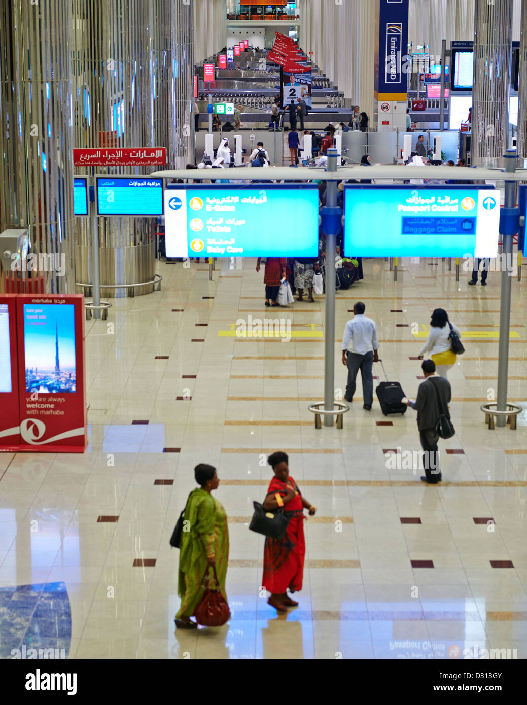Passengers hustle and bustle at the arrival and departure terminal of the Dubai International Airport Stock Photo