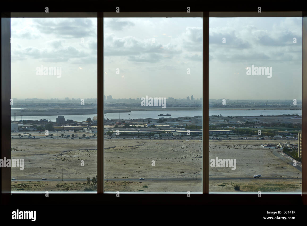 A barren field in Dubai seen through a window Stock Photo