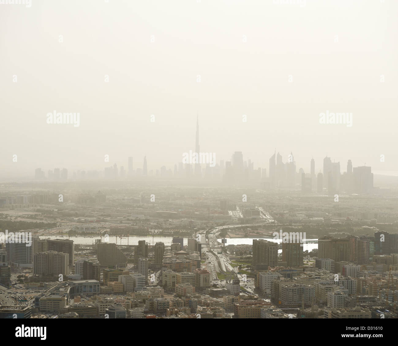 The pollution filled skyline of Dubai, with the towering Burj Khalifa Tower in the distant horizon Stock Photo