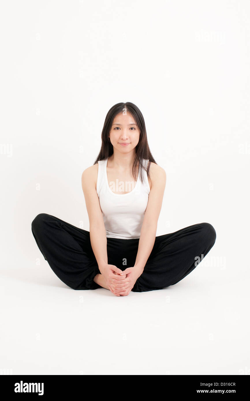 Chinese woman doing yoga Stock Photo
