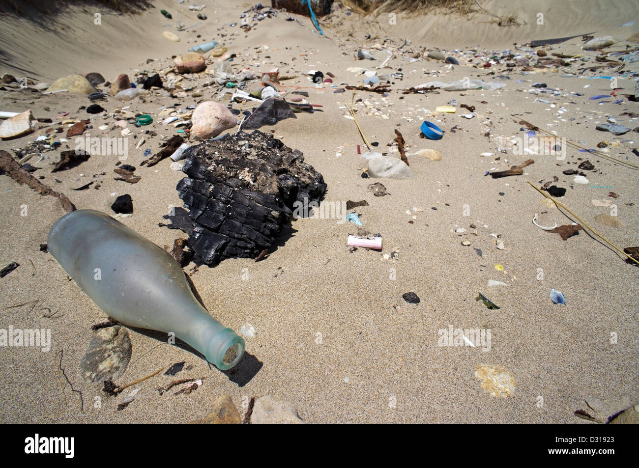 Plastic pollution and glass washed up on a beach, Camargue, France Stock Photo