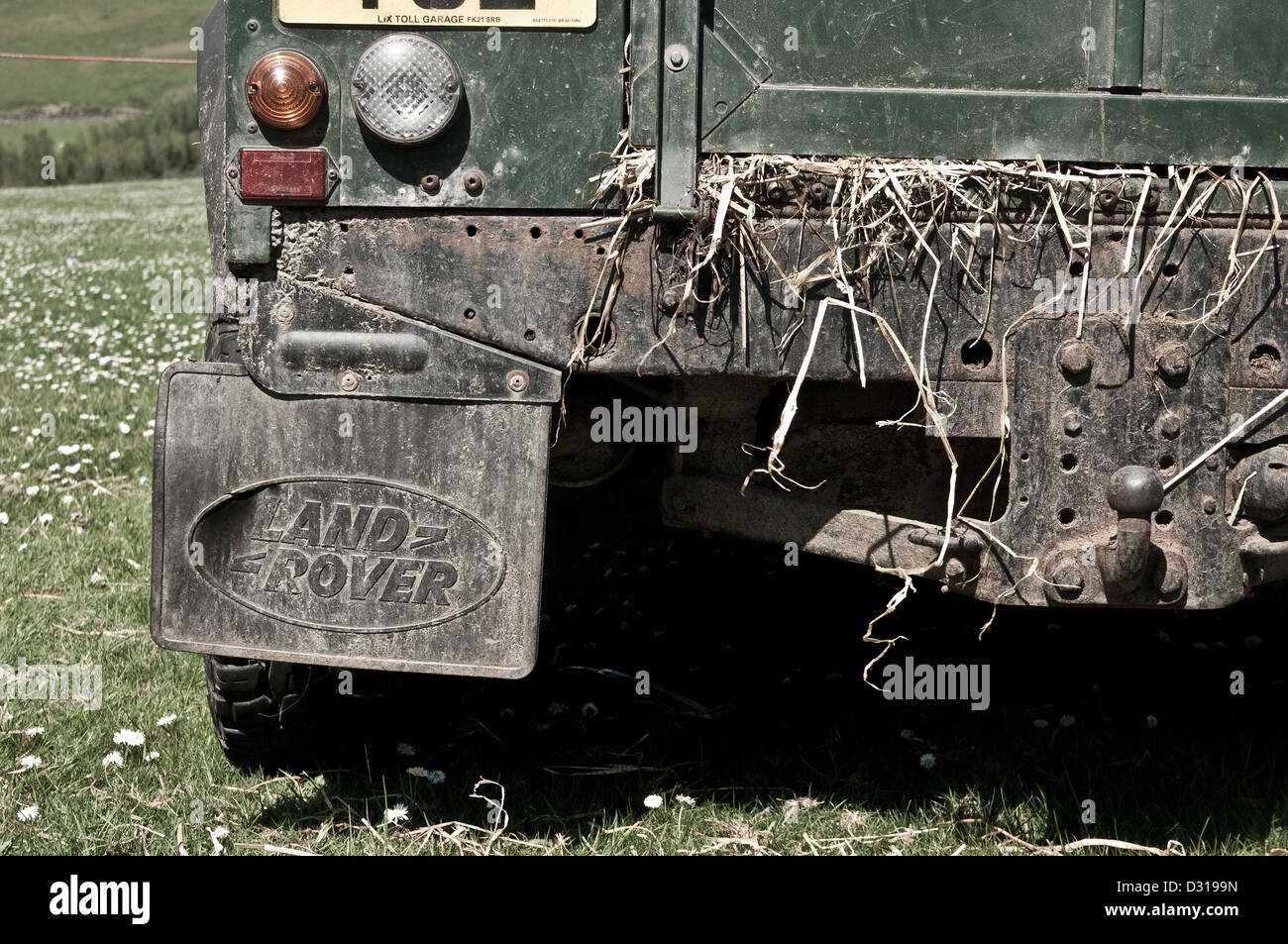 Rear view of land rover with hay hanging out the back door during sheep dog trials Achindaul Fort William Highlands Scotland UK Stock Photo