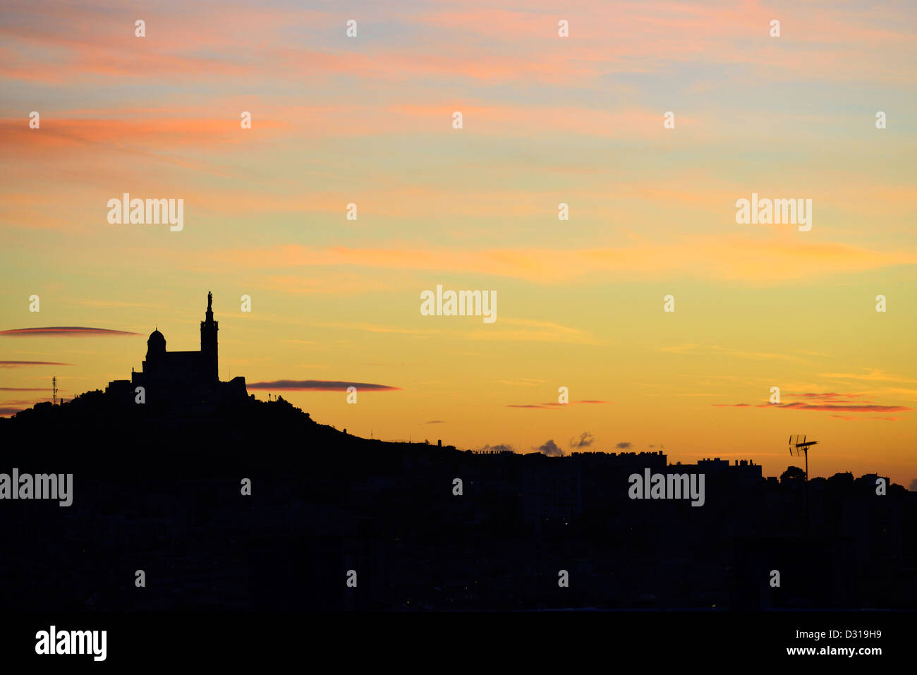 Silhouette and cityscape in Marseille - Notre-Dame-de-la-Garde basilica and city at sunset Stock Photo