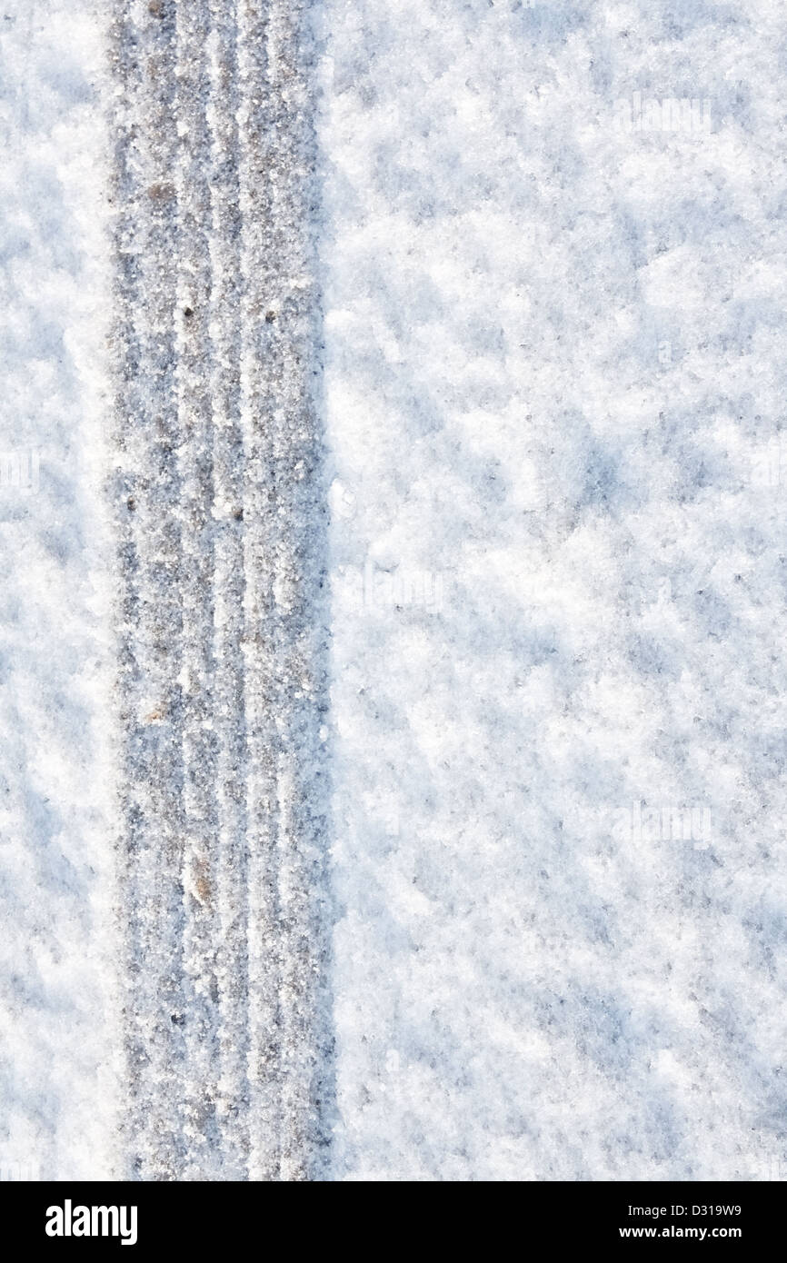 tyre tracks imprinted into fresh snow a great background for rallies or four wheel drive carsty Stock Photo