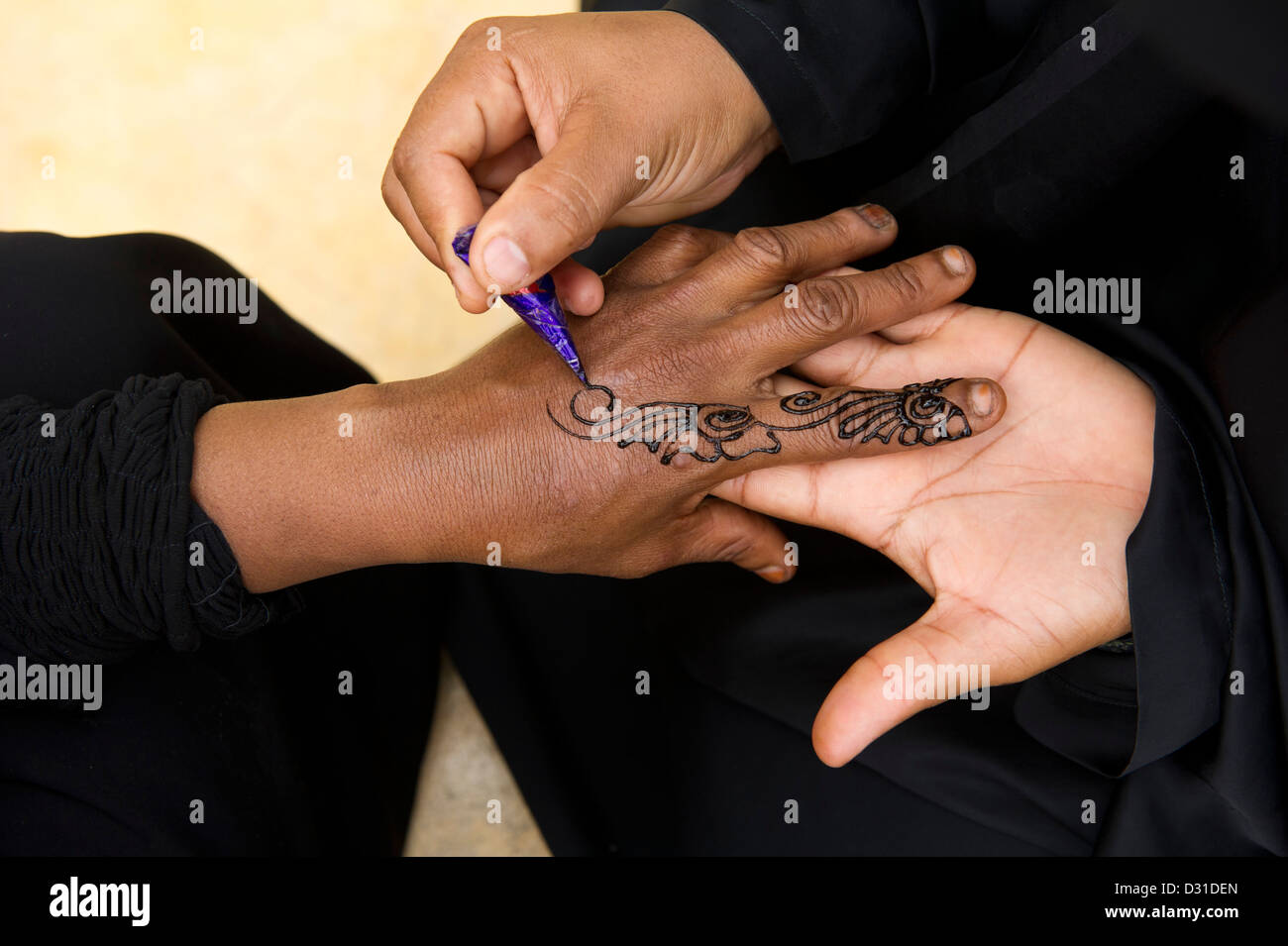 Swahili woman henna painting hands, Lamu, Lamu Archipelago, Kenya Stock Photo