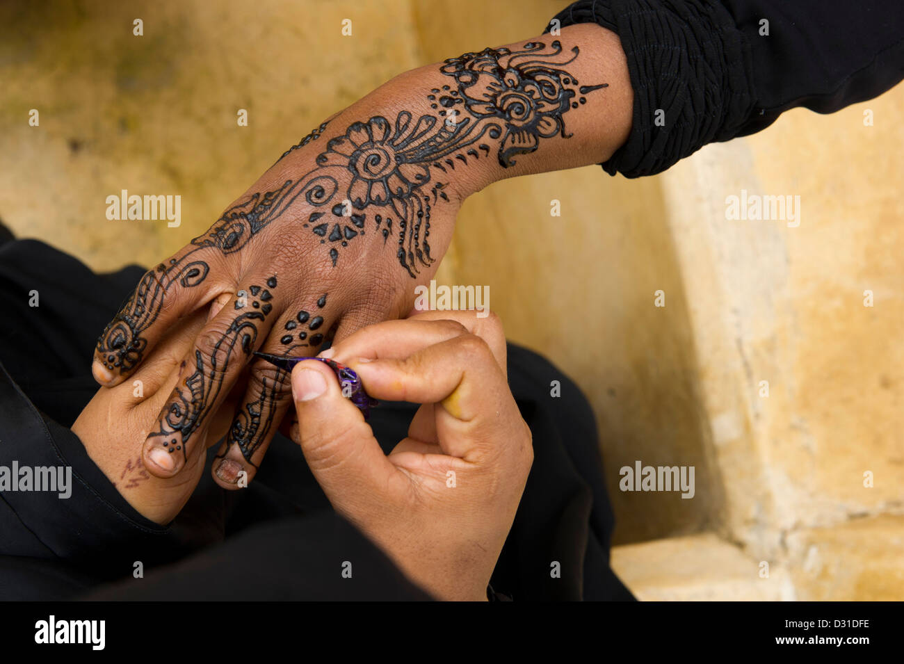 Swahili woman henna painting hands, Lamu, Lamu Archipelago, Kenya Stock