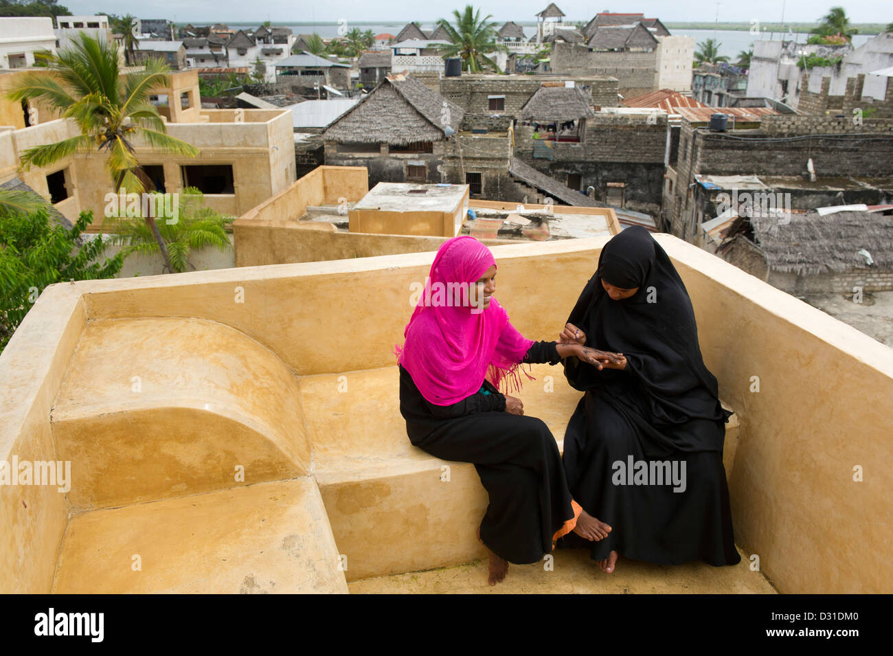 Swahili woman henna painting hands, Lamu, Lamu Archipelago, Kenya Stock Photo