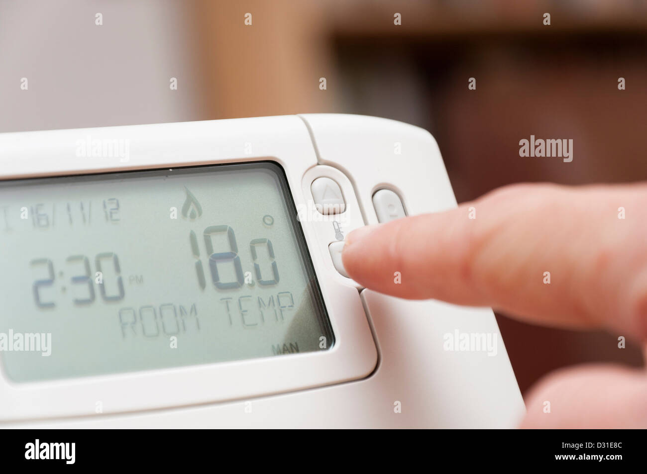 Adjusting room temperature on a home thermostat to save money on