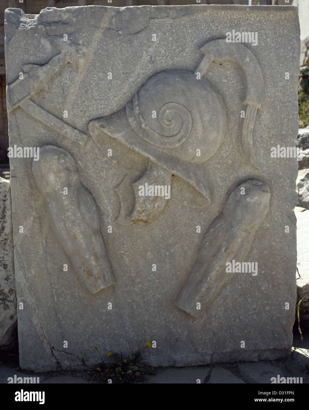 Roman art. Turkey. Military helmet and greaves to protect the legs of the soldiers. Relief. Ephesus. Stock Photo