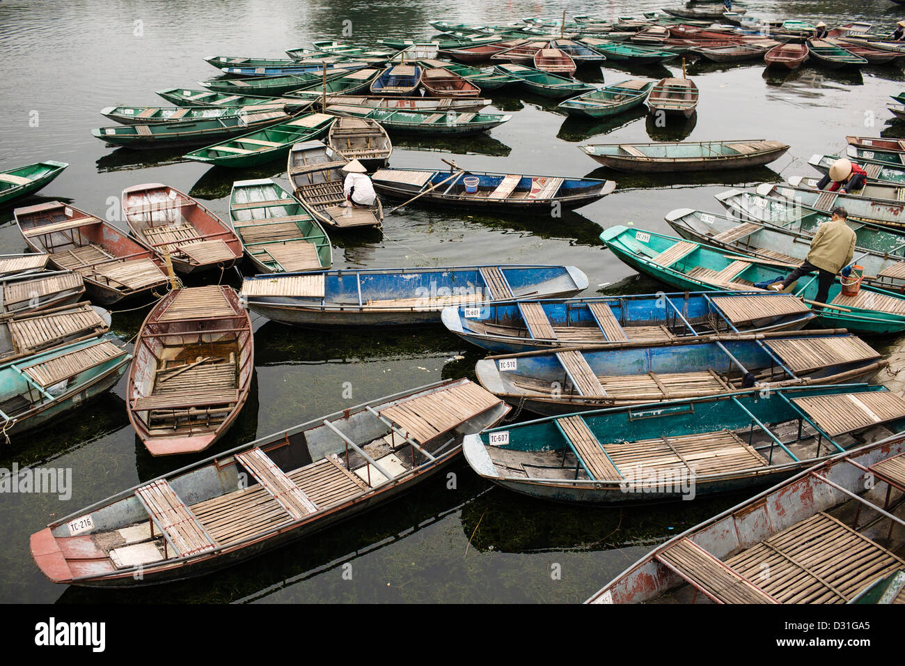 Boats waiting to take tourists on the Ngo Dong river. Tam Coc, Vietnam. Stock Photo