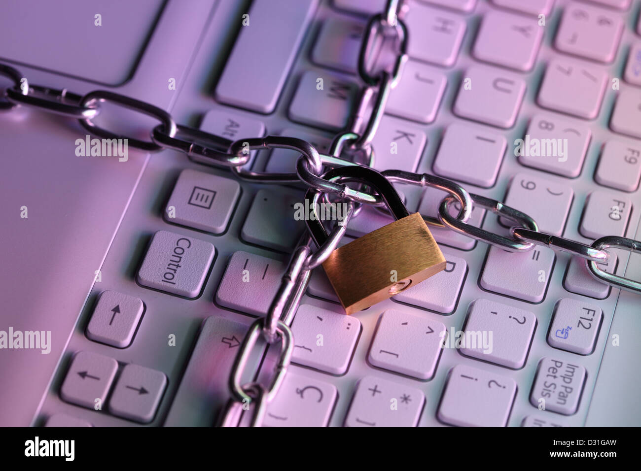 Laptop keyboard locked with a padlock. Computer security concept Stock Photo