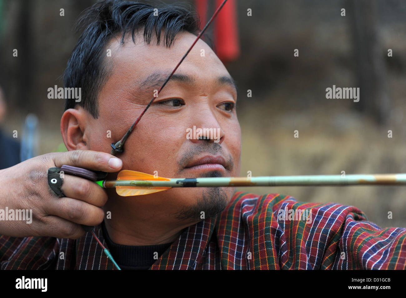 Bhutanese man practicing archery, the country's national sport. Stock Photo