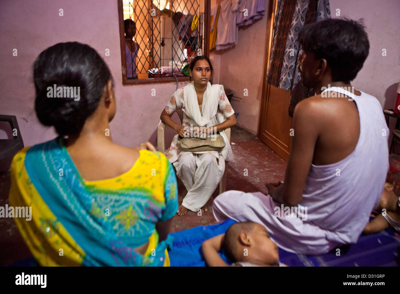 An outreach worker who works for Operation Asha health clinic in Delhi, India. Visiting patients at home. Stock Photo