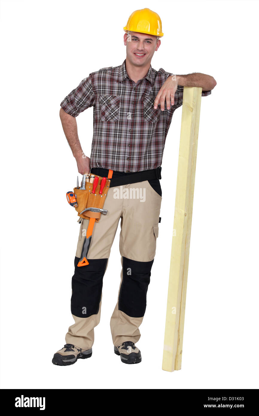 Carpenter stood with plank of wood Stock Photo
