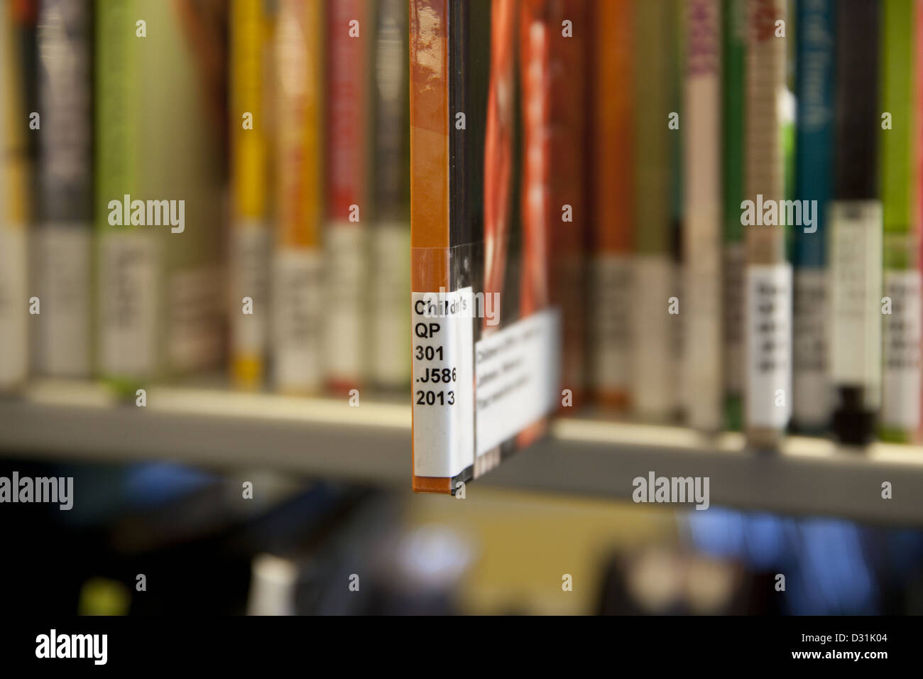 Library of Congress System call# label on the spine of a book in the children's section of a public library Stock Photo