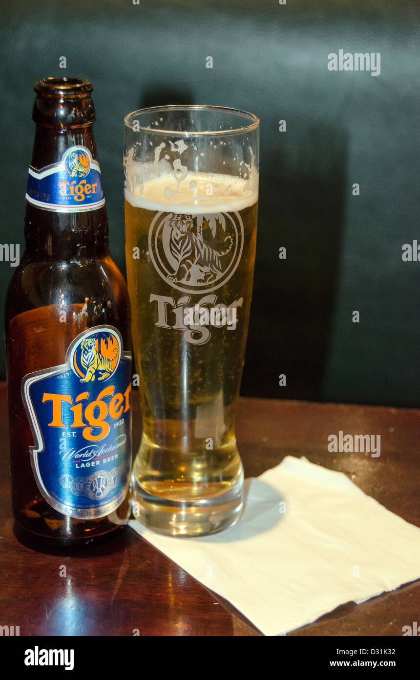 Close up of Tiger Beer and full glass on table Stock Photo