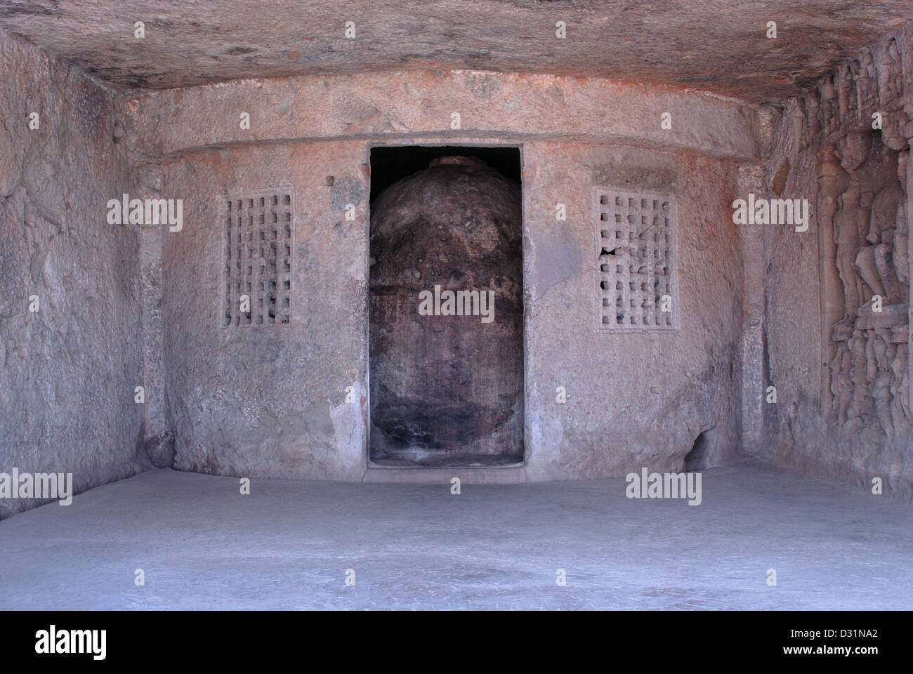 Stupa in a rock-cut chamber with two perforated windows on either side. Kondivita, Mahakali Caves Mumbai, Maharashtra, India Stock Photo