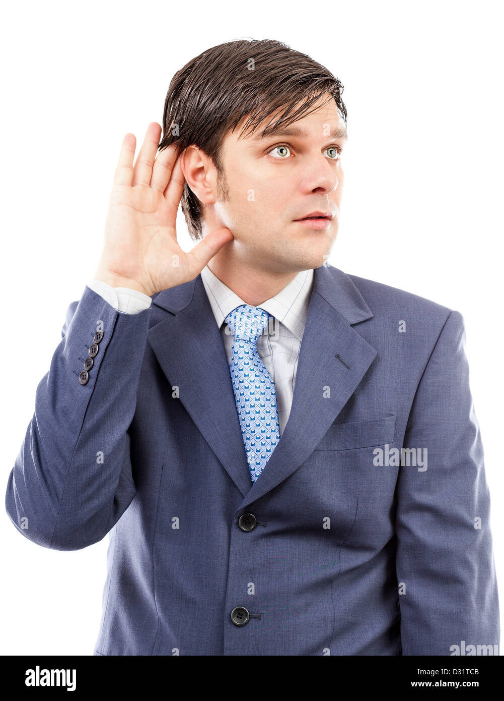Young business man holding his hand to his ear isolated on white Stock Photo