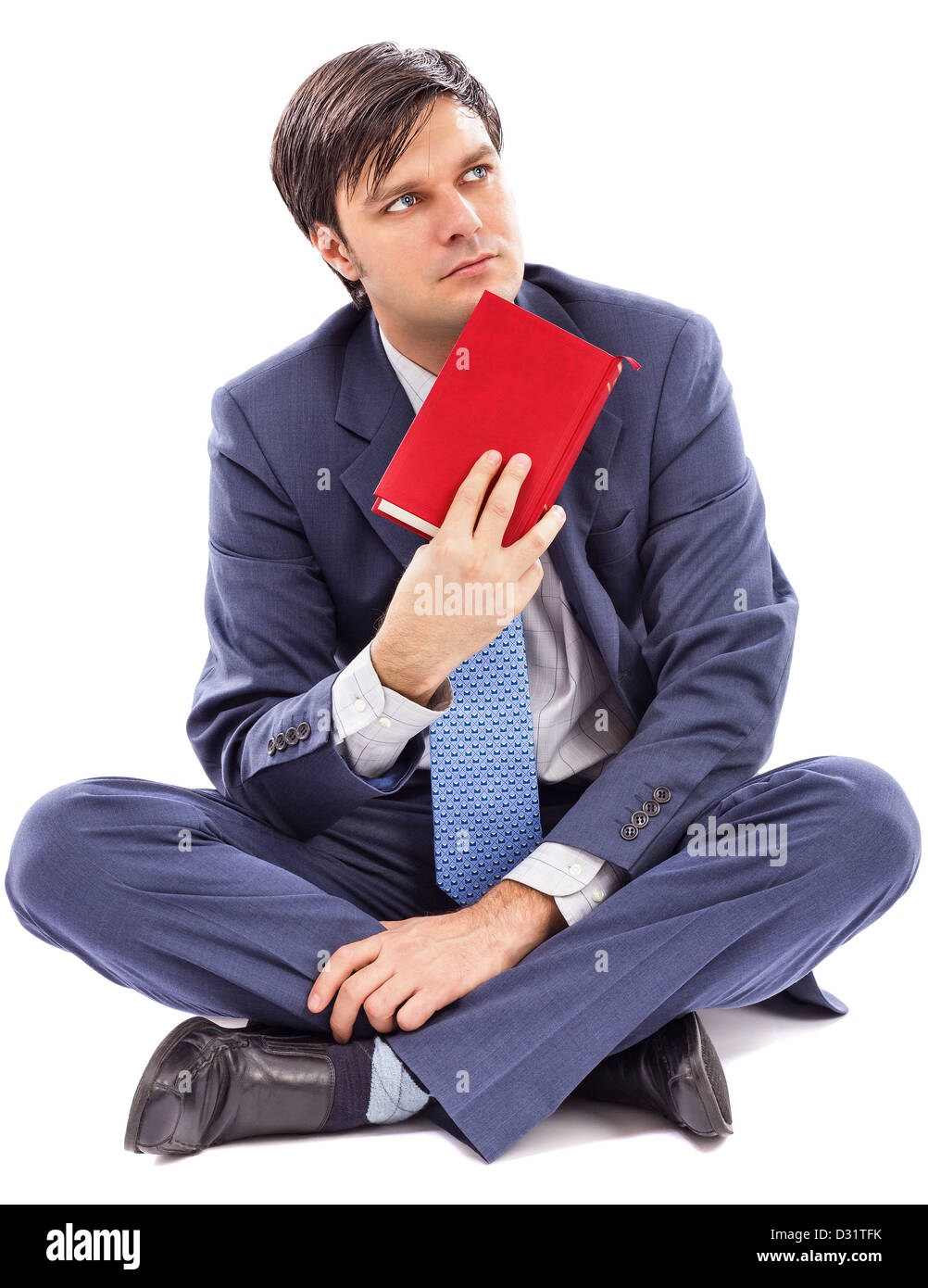 Portrait of a young businessman holding a book against white background Stock Photo