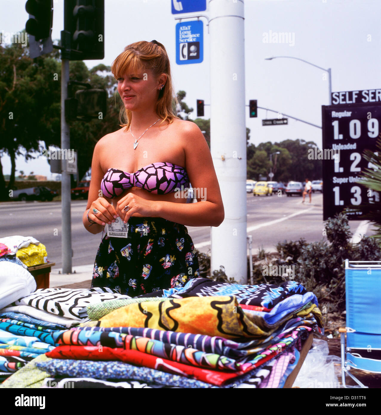 A young woman selling homemade trousers on the Pacific Coast Highway Malibu Los Angeles California 1980s 1990s 80s 90s  KATHY DEWITT Stock Photo