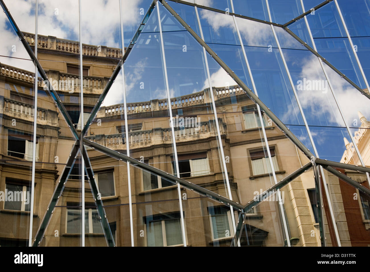 Reflection of an old building in the glass of a modern building Stock Photo