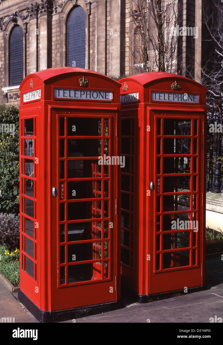 Two traditional red telephone boxes outside St Paul's Cathedral City of London England UK Stock Photo