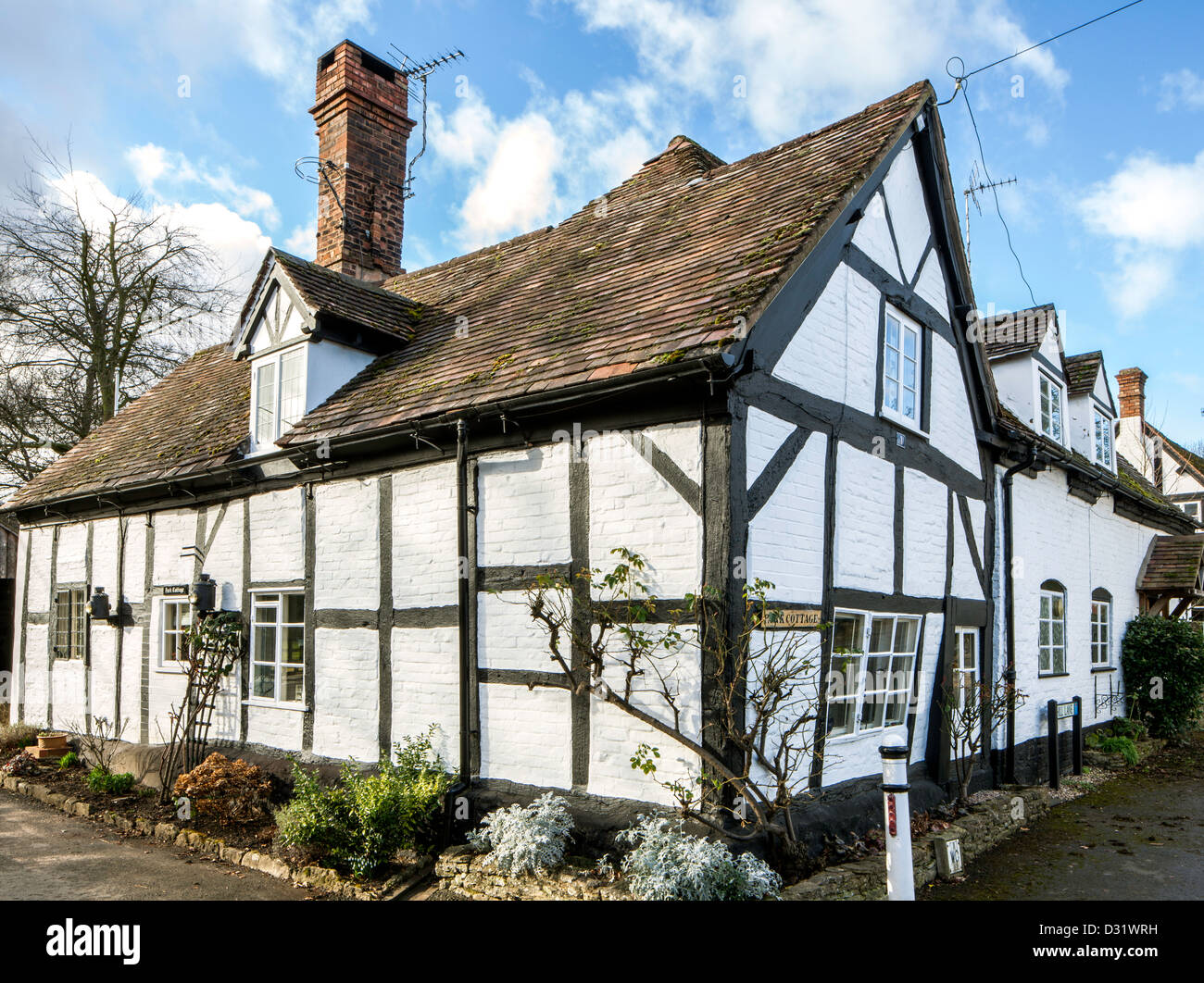 Half timbered thatched cottage in the village of Bredon, Worcestershire, England, UK Stock Photo