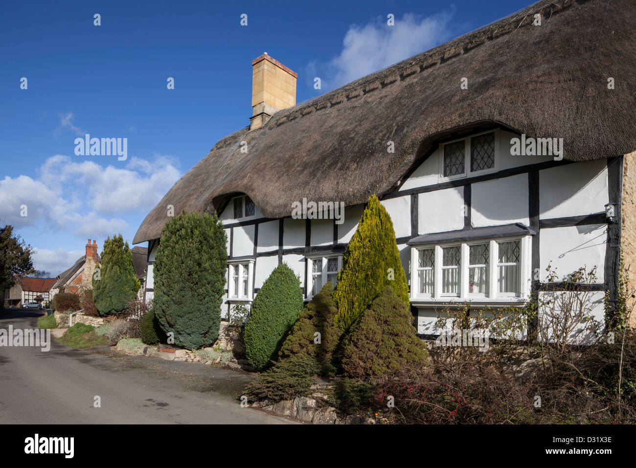 Half timbered thatched cottage in the village of Bredon, Worcestershire, England, UK Stock Photo